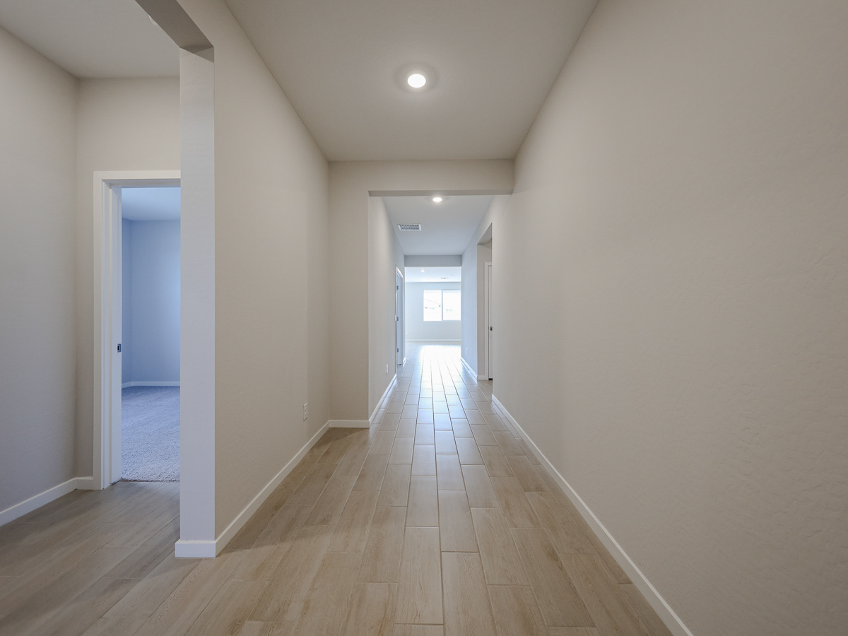 A long hallway with white walls.