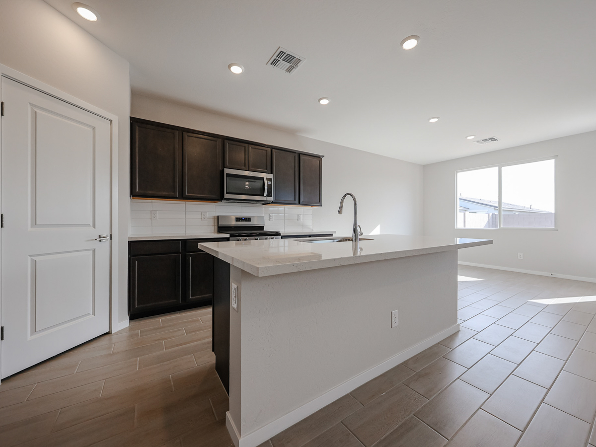 A kitchen with black cabinets.