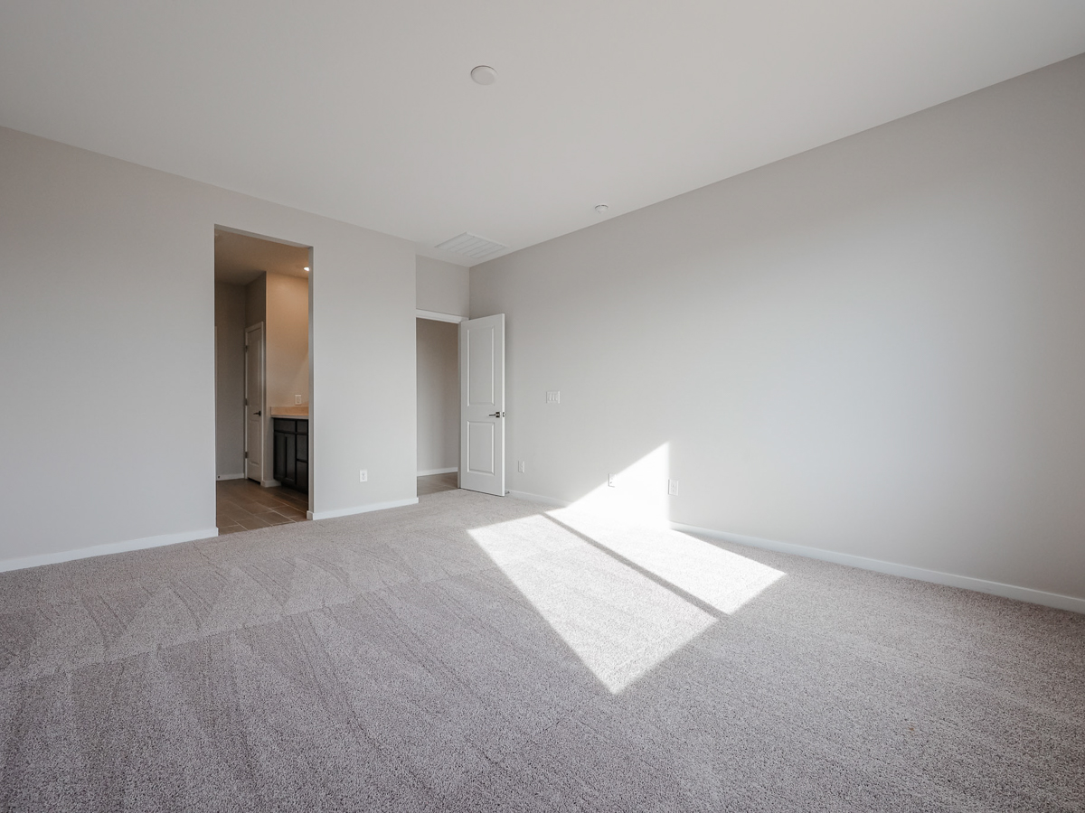 A long hallway with white walls.