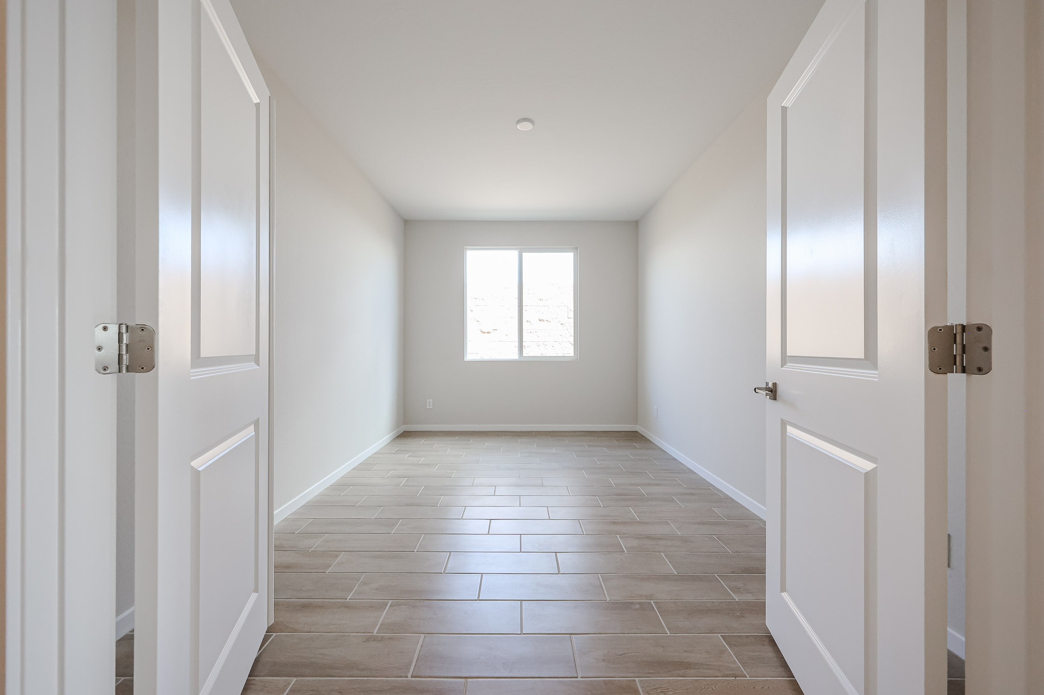 A hallway with white doors.