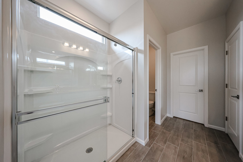 A bathroom with white cabinets.