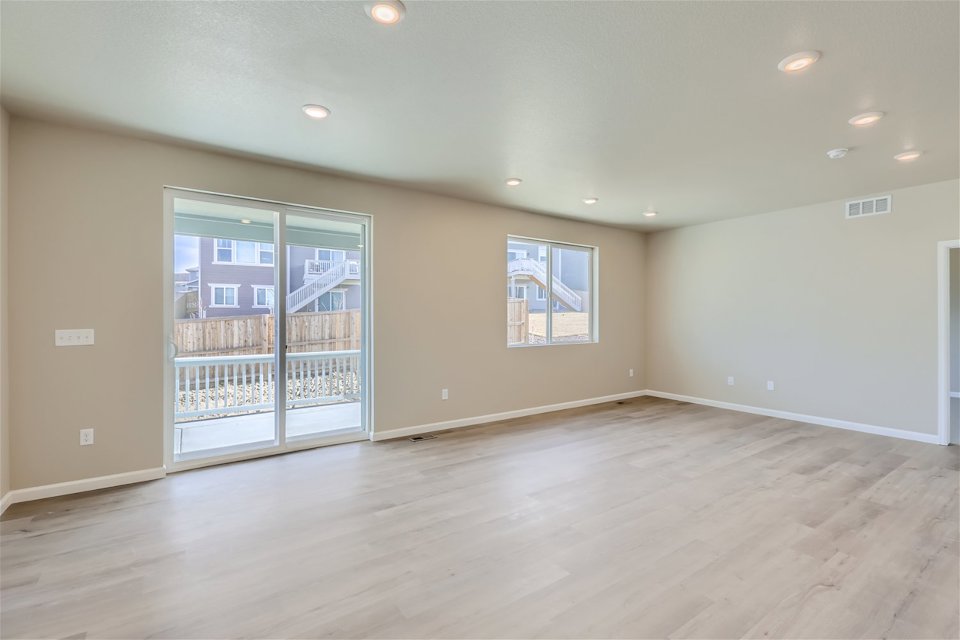A room with a wood floor and a glass door.