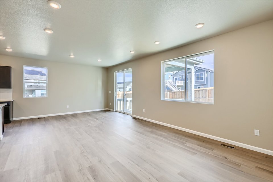 A room with a wood floor and a window.