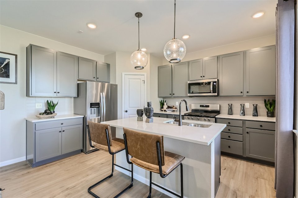 A kitchen with white cabinets.