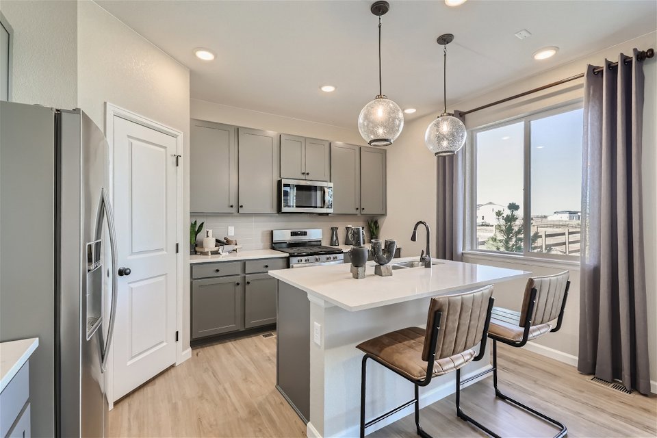 A kitchen with white cabinets.