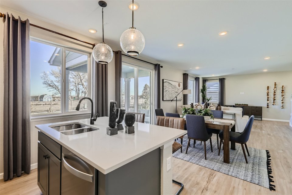A kitchen with a large window.
