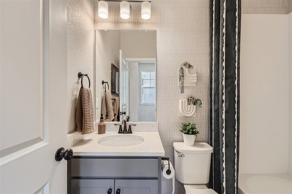 A bathroom with a sink and a mirror.