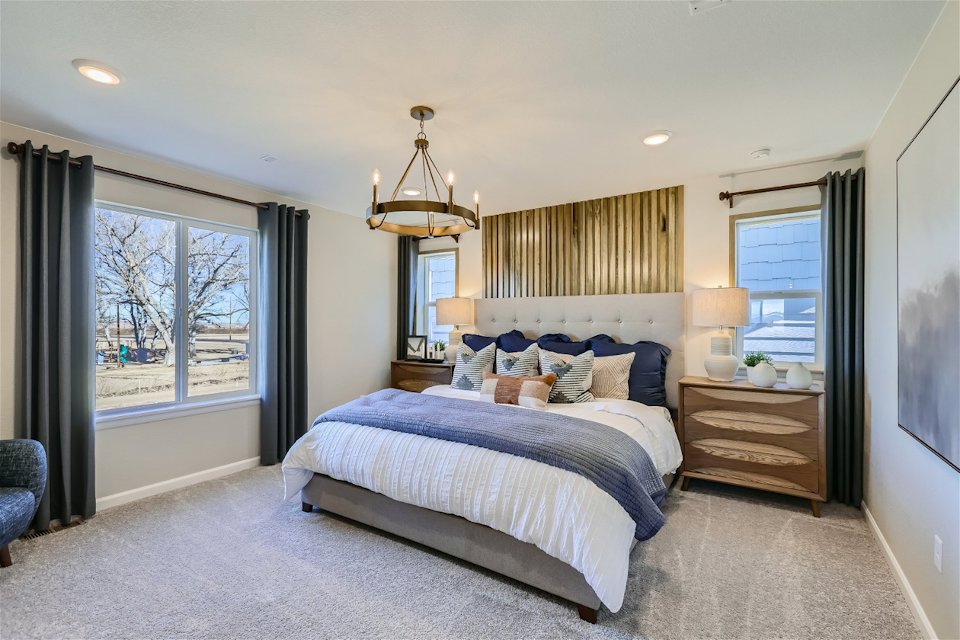 A bedroom with a bed and a window.