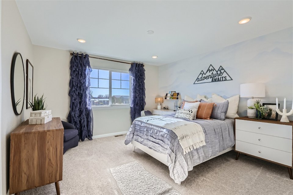 A bedroom with a bed and a window.