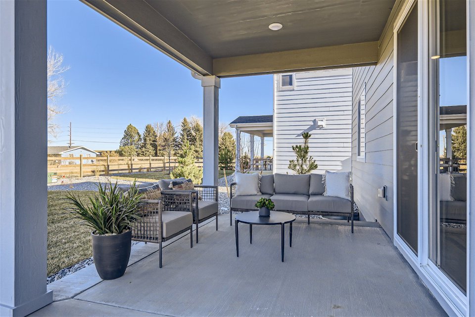 A patio with a table and chairs.