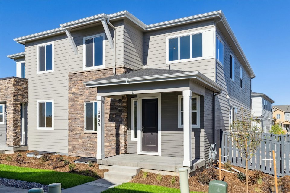 A grey house with a white door.