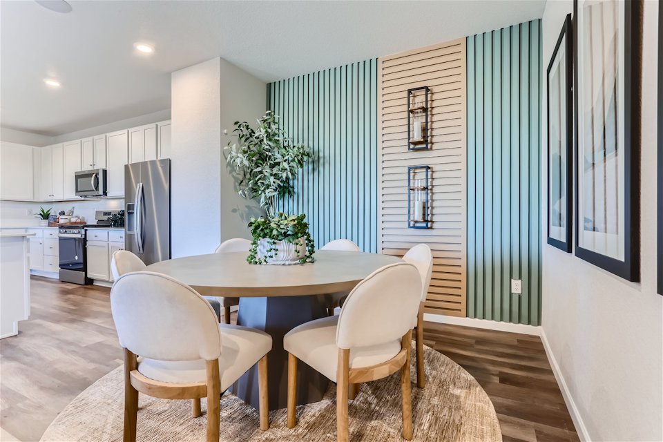 A dining room with a table and chairs.