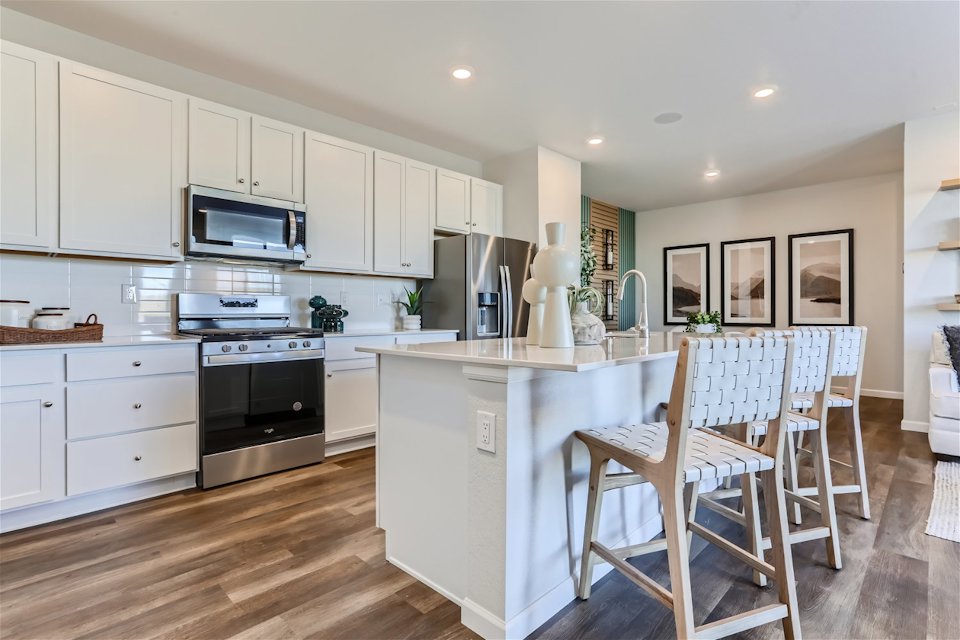A kitchen with white cabinets.