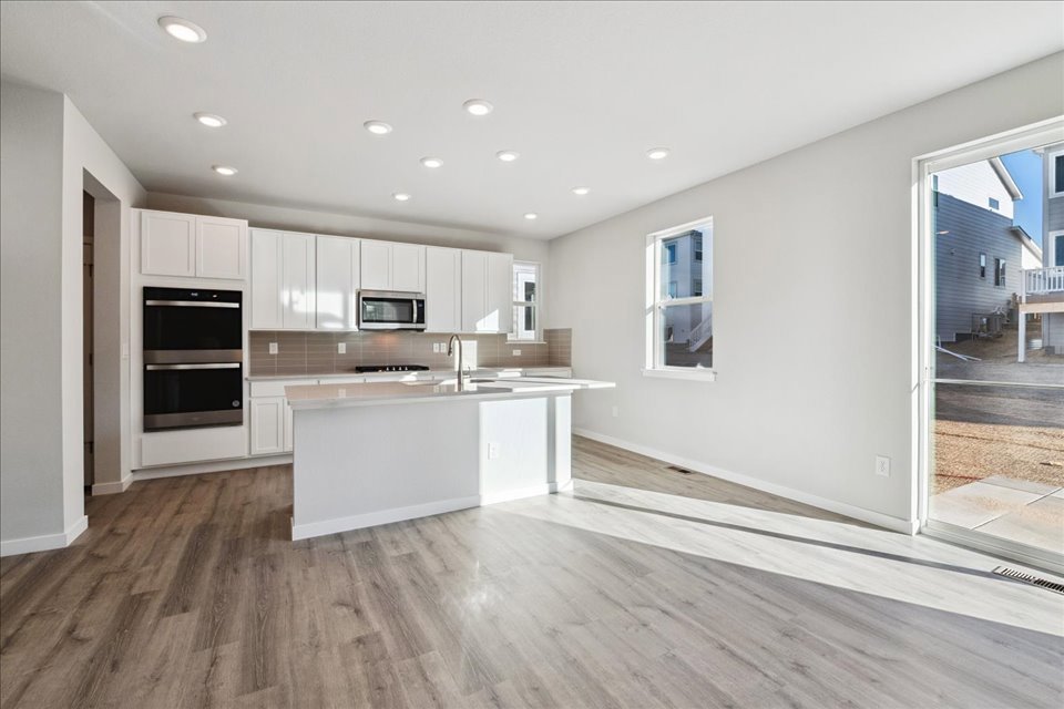 A kitchen with white cabinets.