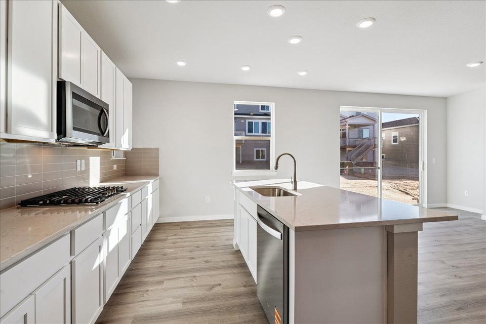 A kitchen with white cabinets.