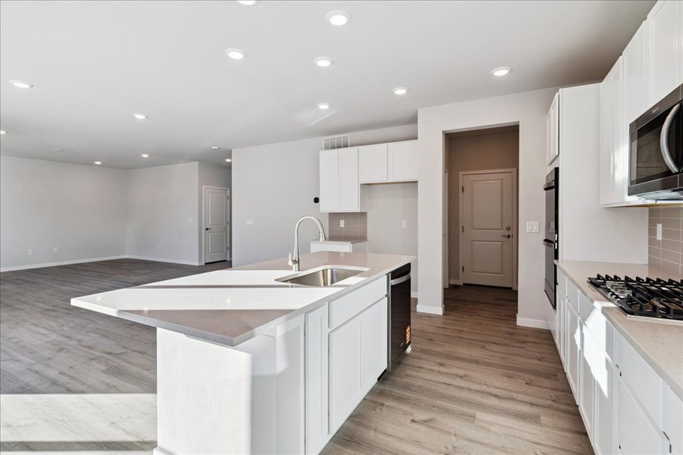 A kitchen with white cabinets.