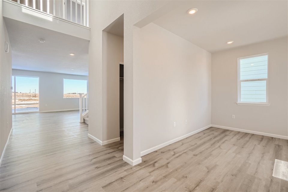 A room with a wood floor and white walls.