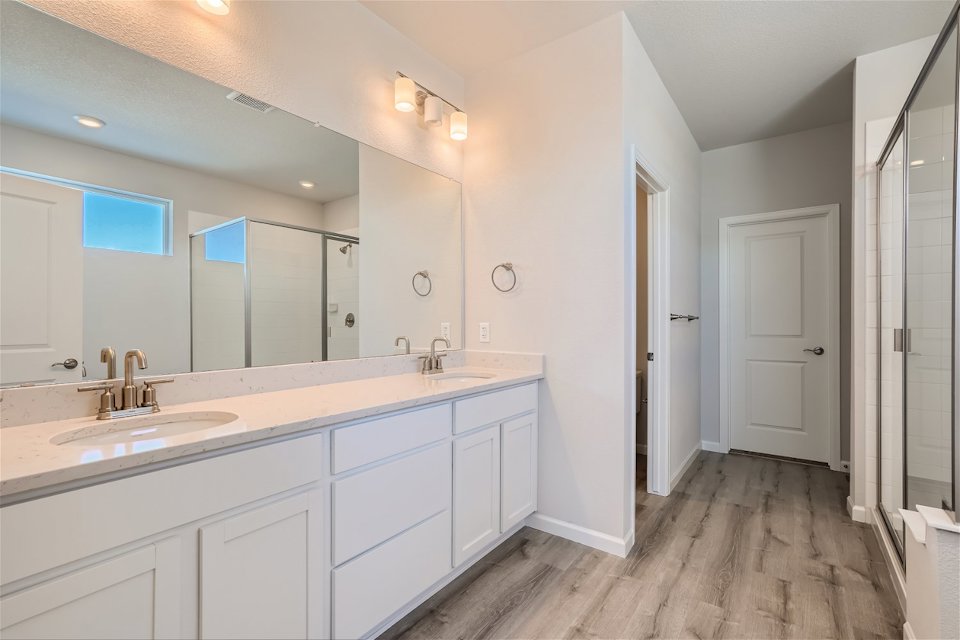 A bathroom with white cabinets.