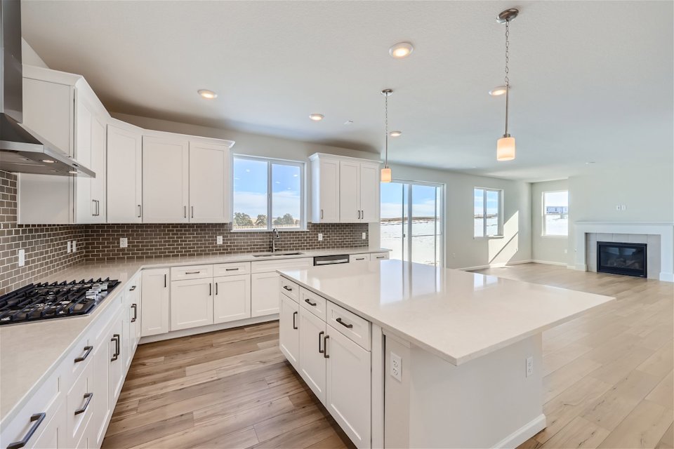 A kitchen with white cabinets.