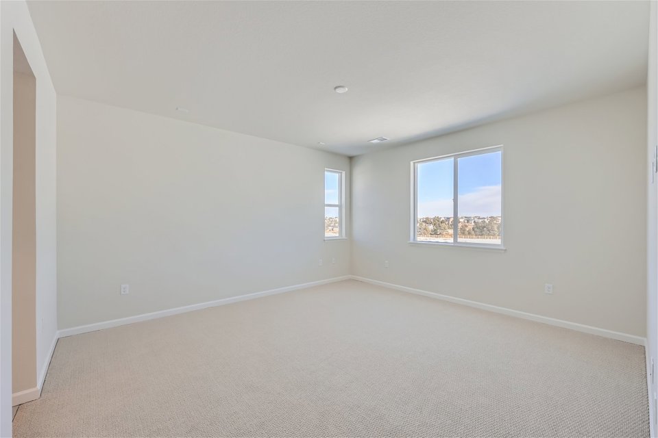 A room with a window and a carpet.