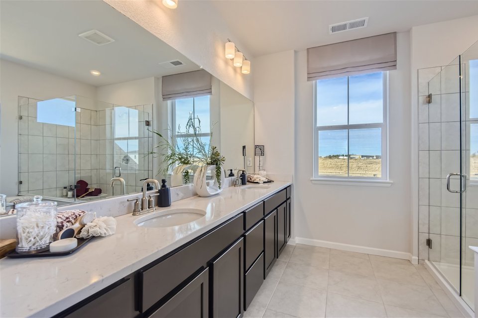A bathroom with a large mirror.
