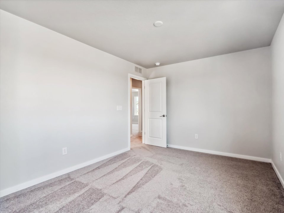 A hallway with white walls.