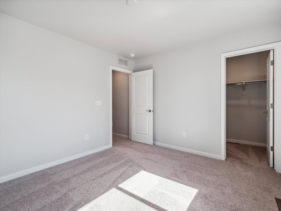 A room with a rug and a door.