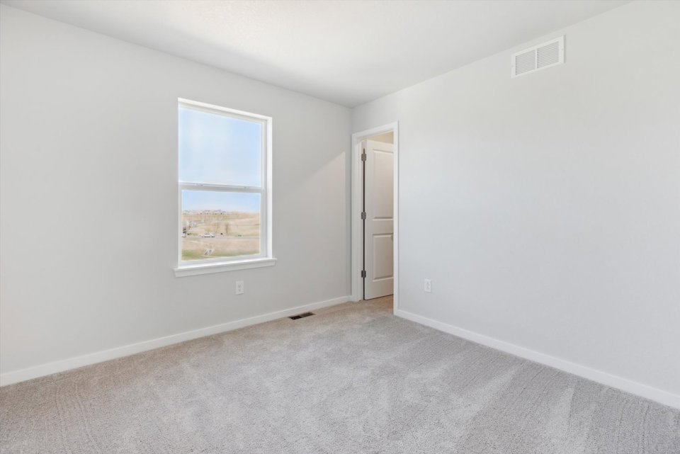 A room with a window and a door.