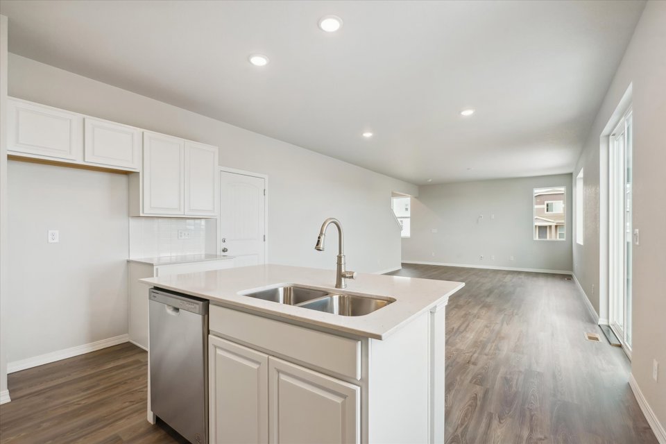 A kitchen with white cabinets.