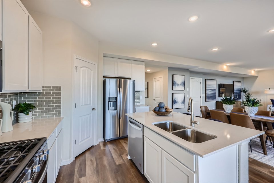 A kitchen with white cabinets.