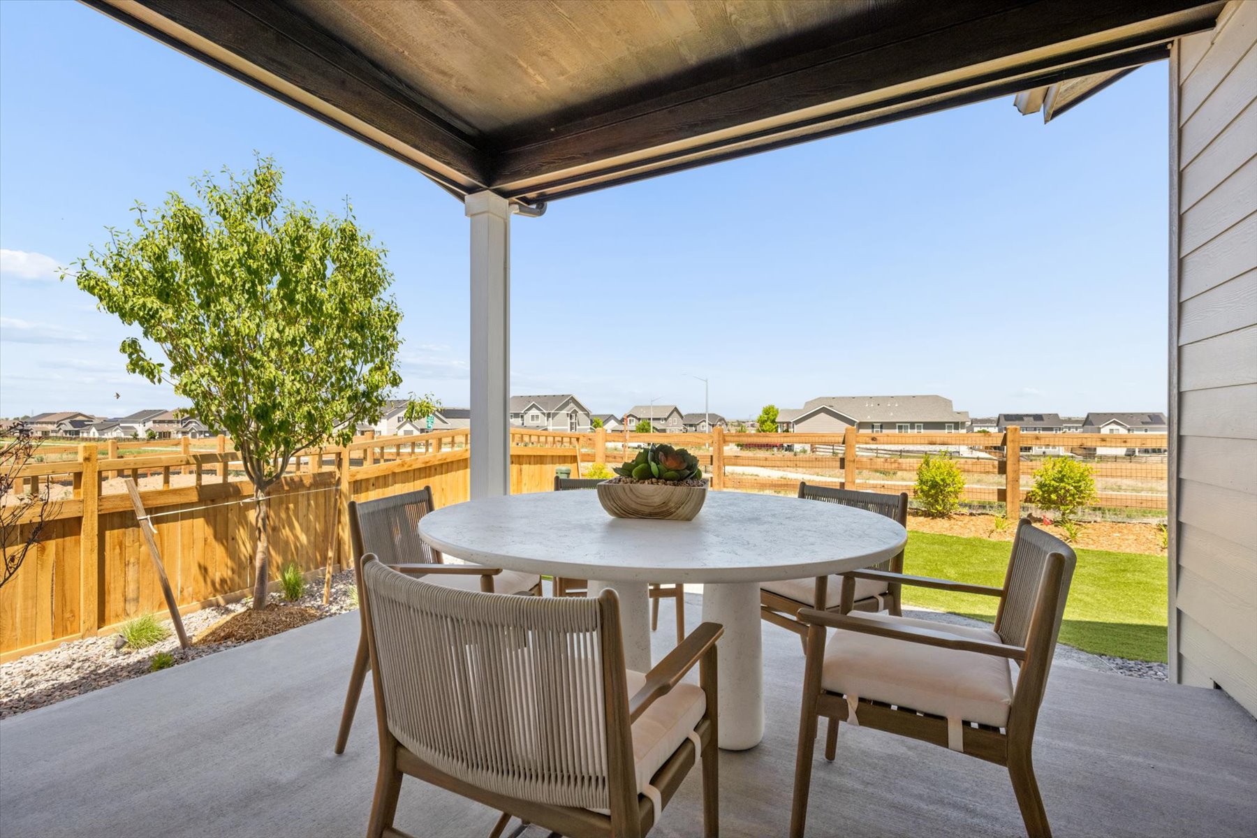 A table and chairs on a deck.