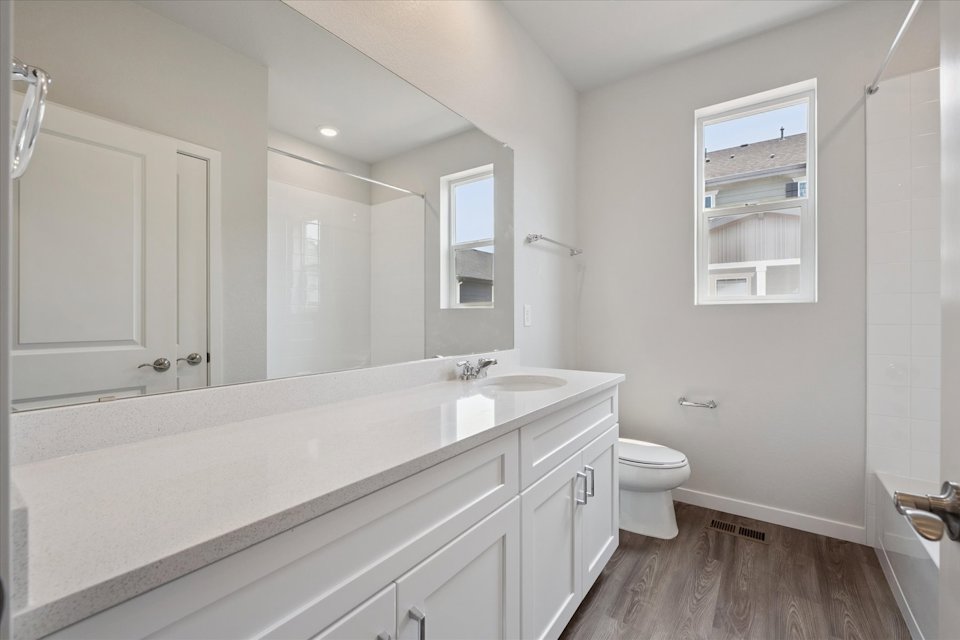 A bathroom with a large mirror.