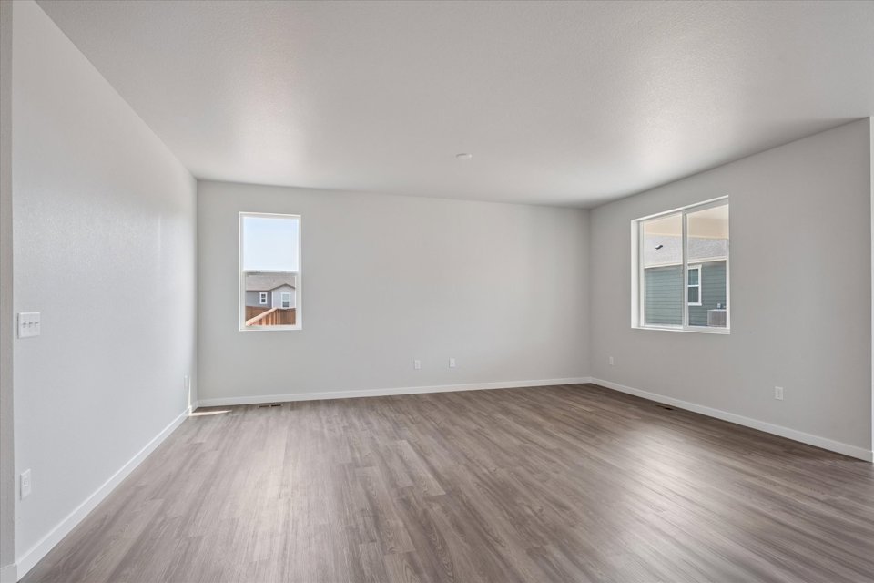 A room with a wood floor and white walls.