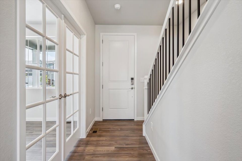A hallway with white doors.