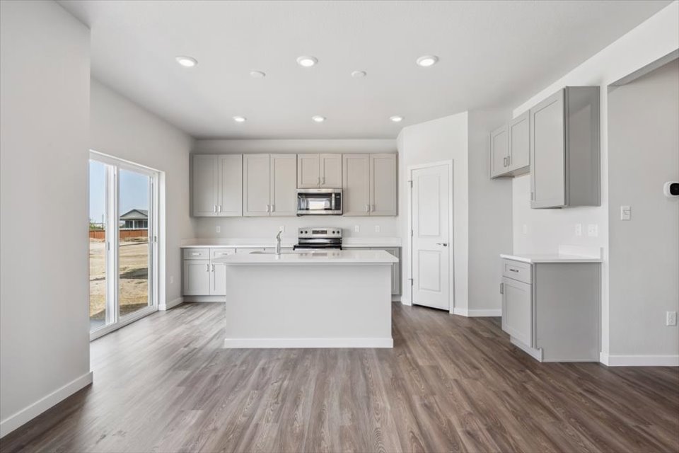 A kitchen with white cabinets.