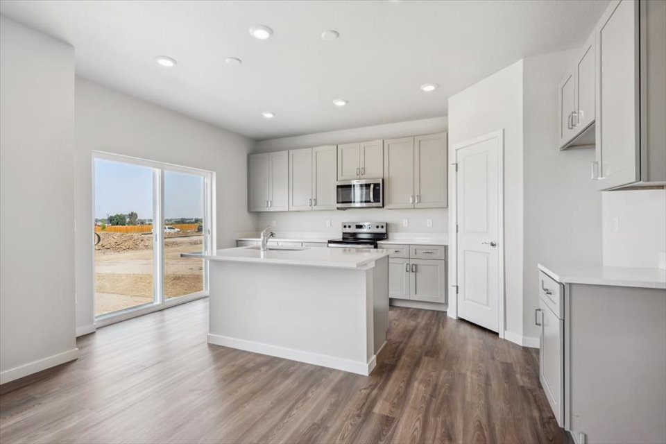 A kitchen with white cabinets.