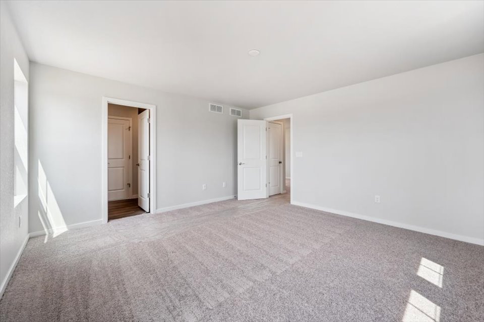 A hallway with white doors.