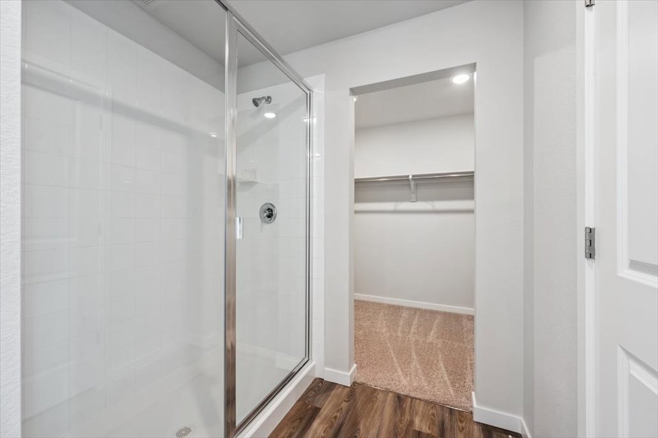 A shower with a glass door.