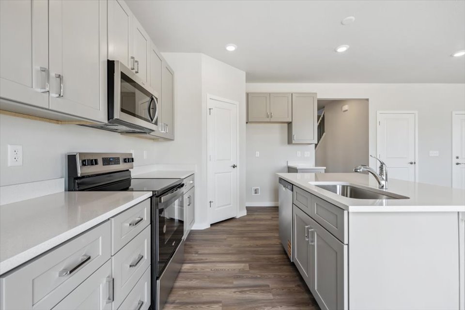 A kitchen with white cabinets.