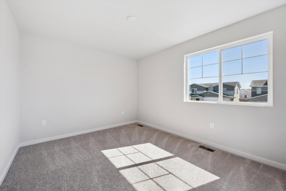 A room with a window and a tile floor.