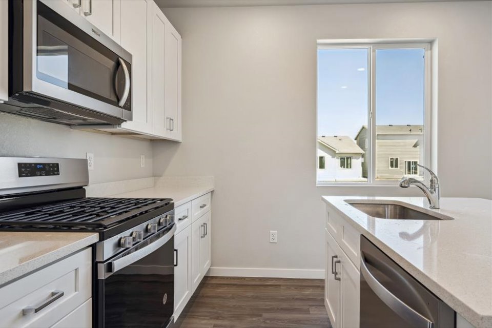 A kitchen with white cabinets.
