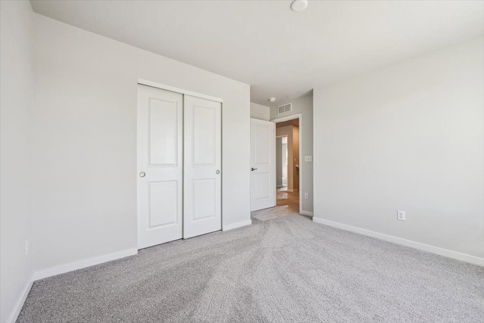 A hallway with white doors.