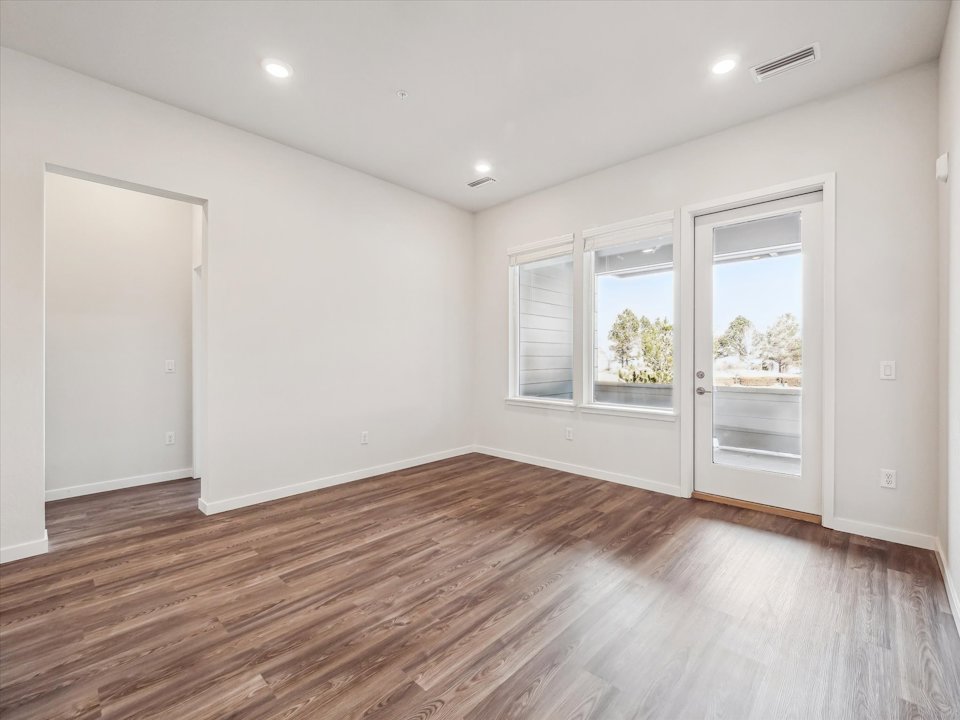 A room with white walls and a wood floor.