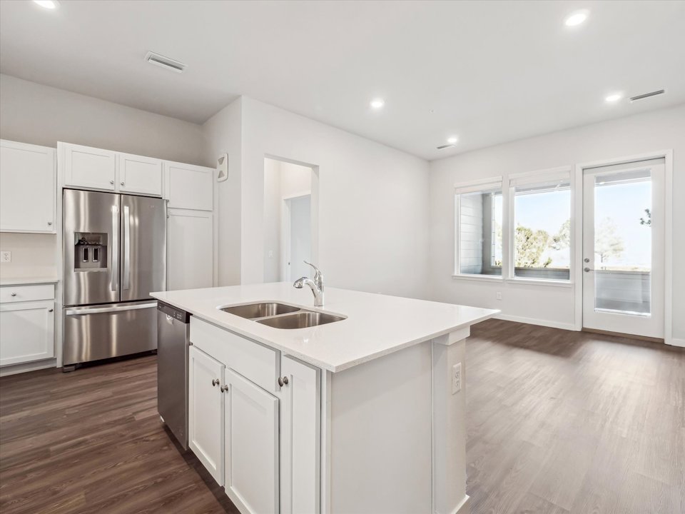 A kitchen with white cabinets.