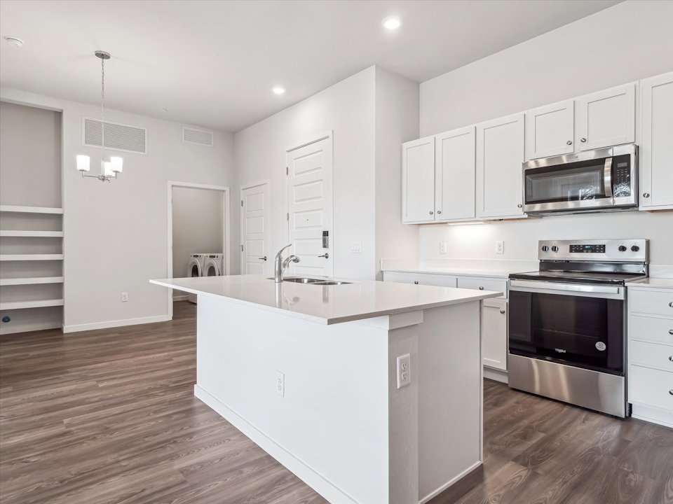 A kitchen with white cabinets.