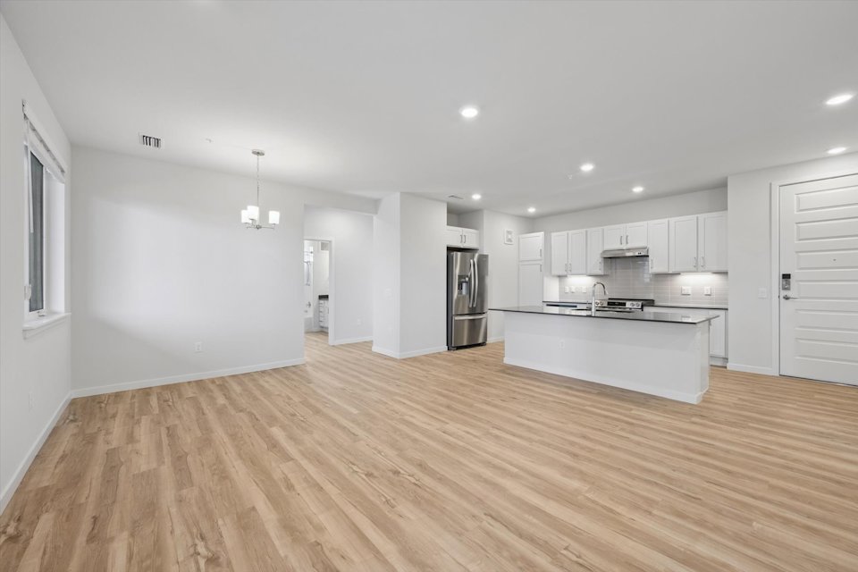 A large kitchen with white cabinets.