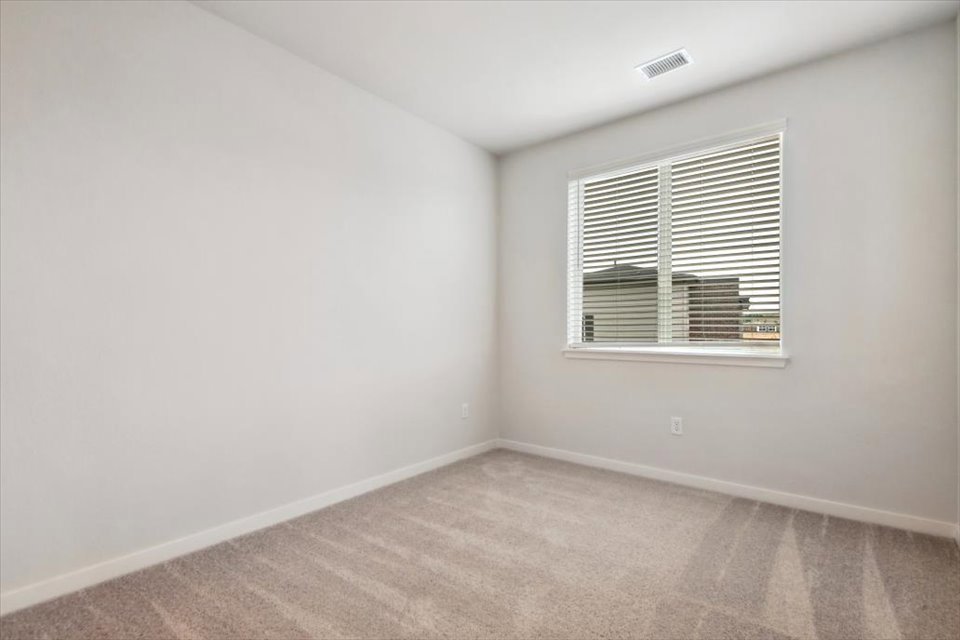 A room with a window and a vent.