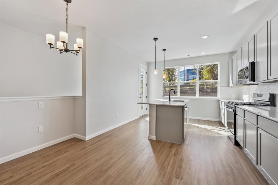 A kitchen with a wood floor.