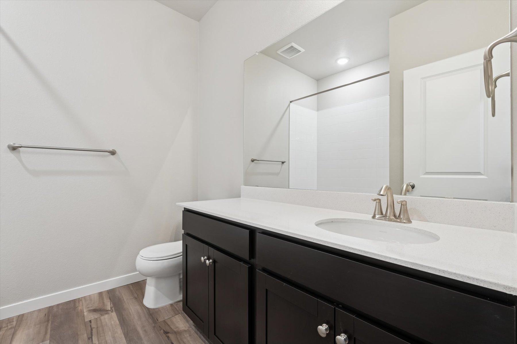 A bathroom with a large mirror.