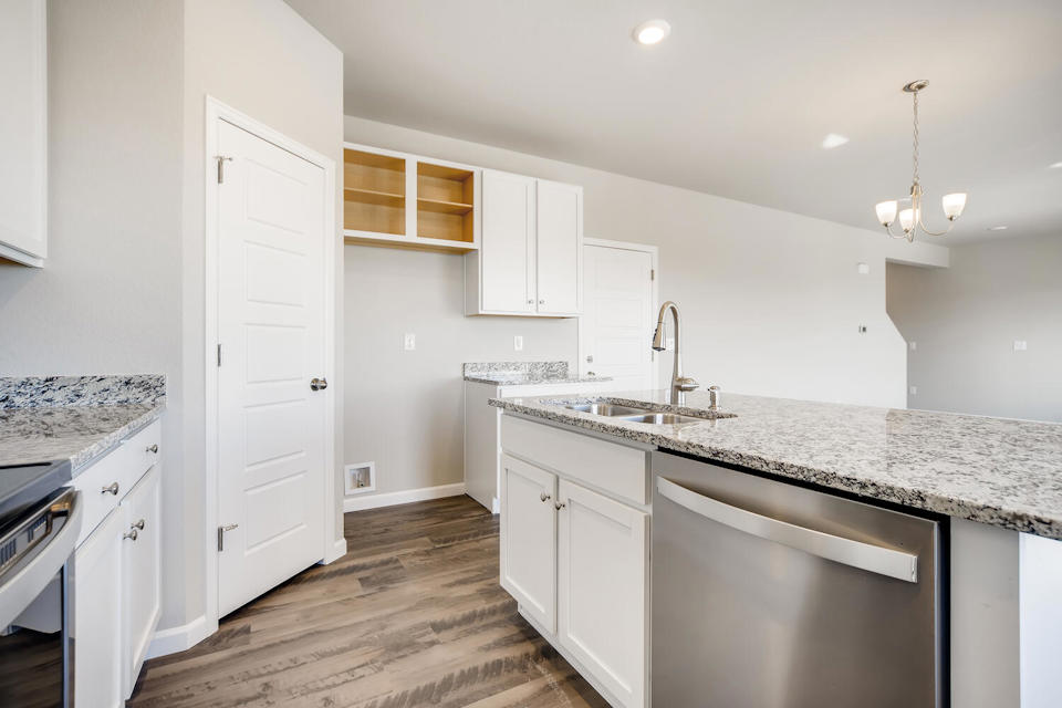 A kitchen with white cabinets.